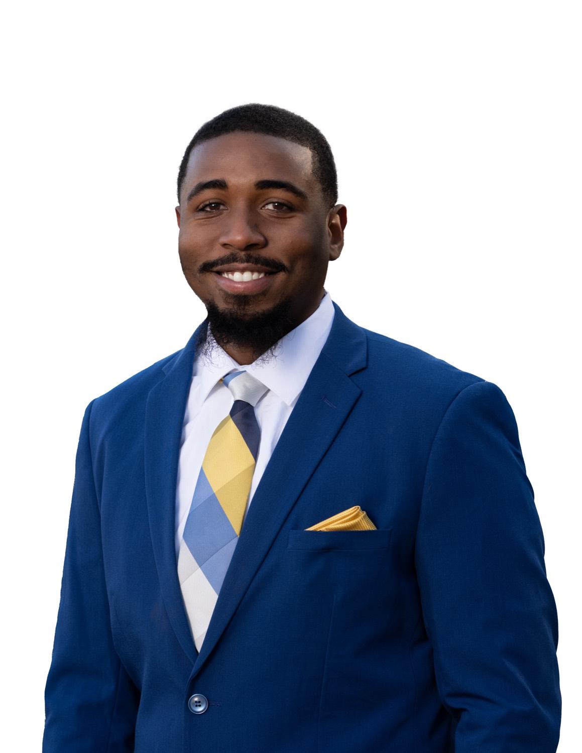 Professional headshot of a man in a blue suit
