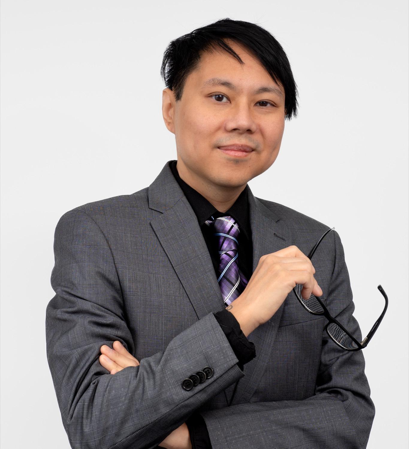 Professional headshot of a man on a clean background