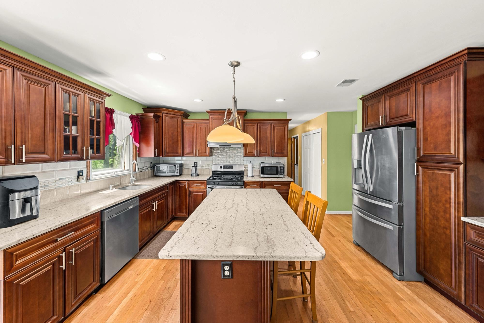 Traditional wood-cabinet kitchen with granite island