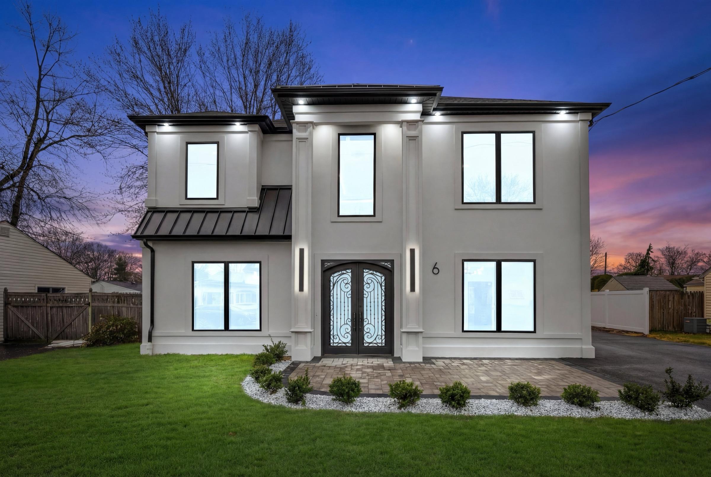 Home exterior at twilight with enhanced lawn