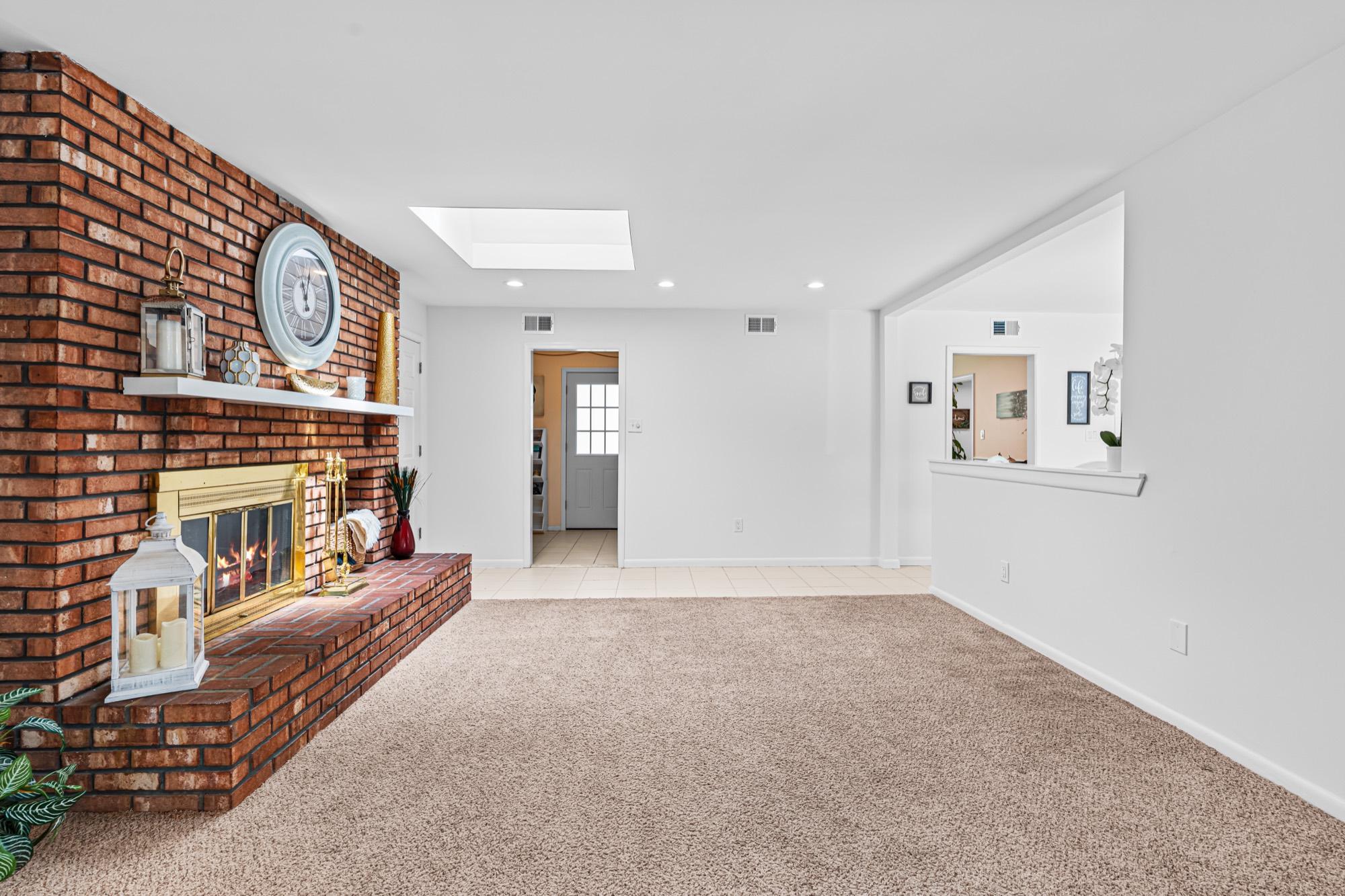 Living room with a floor-to-ceiling brick fireplace