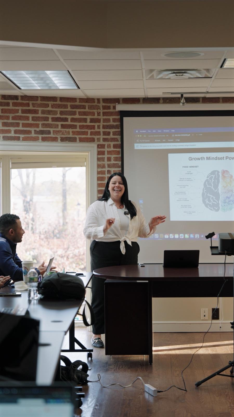 Speaker presenting to the team during a filmed office meeting