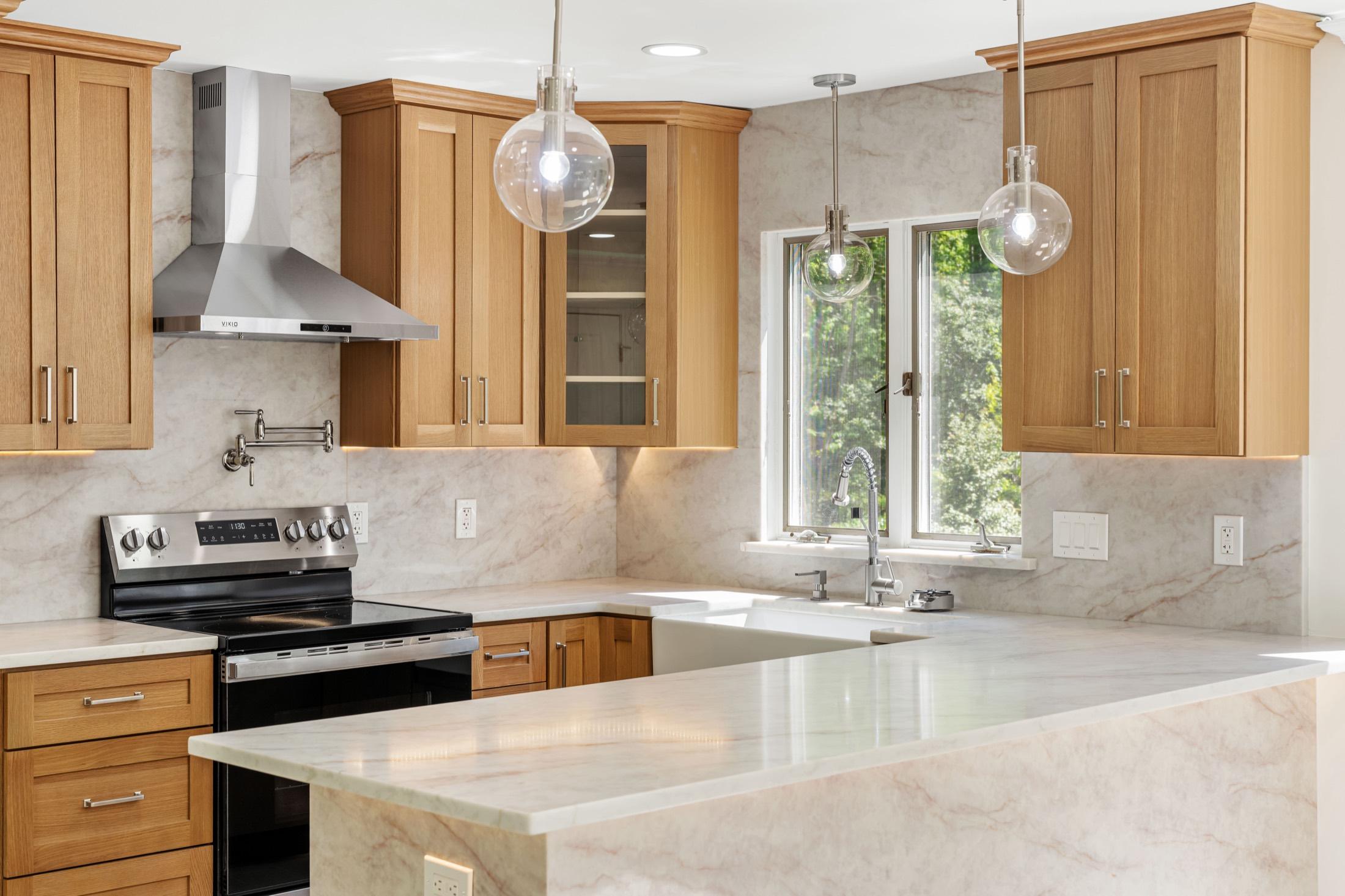Warm wood kitchen with marble counters and pendant lighting, Cranbury NJ