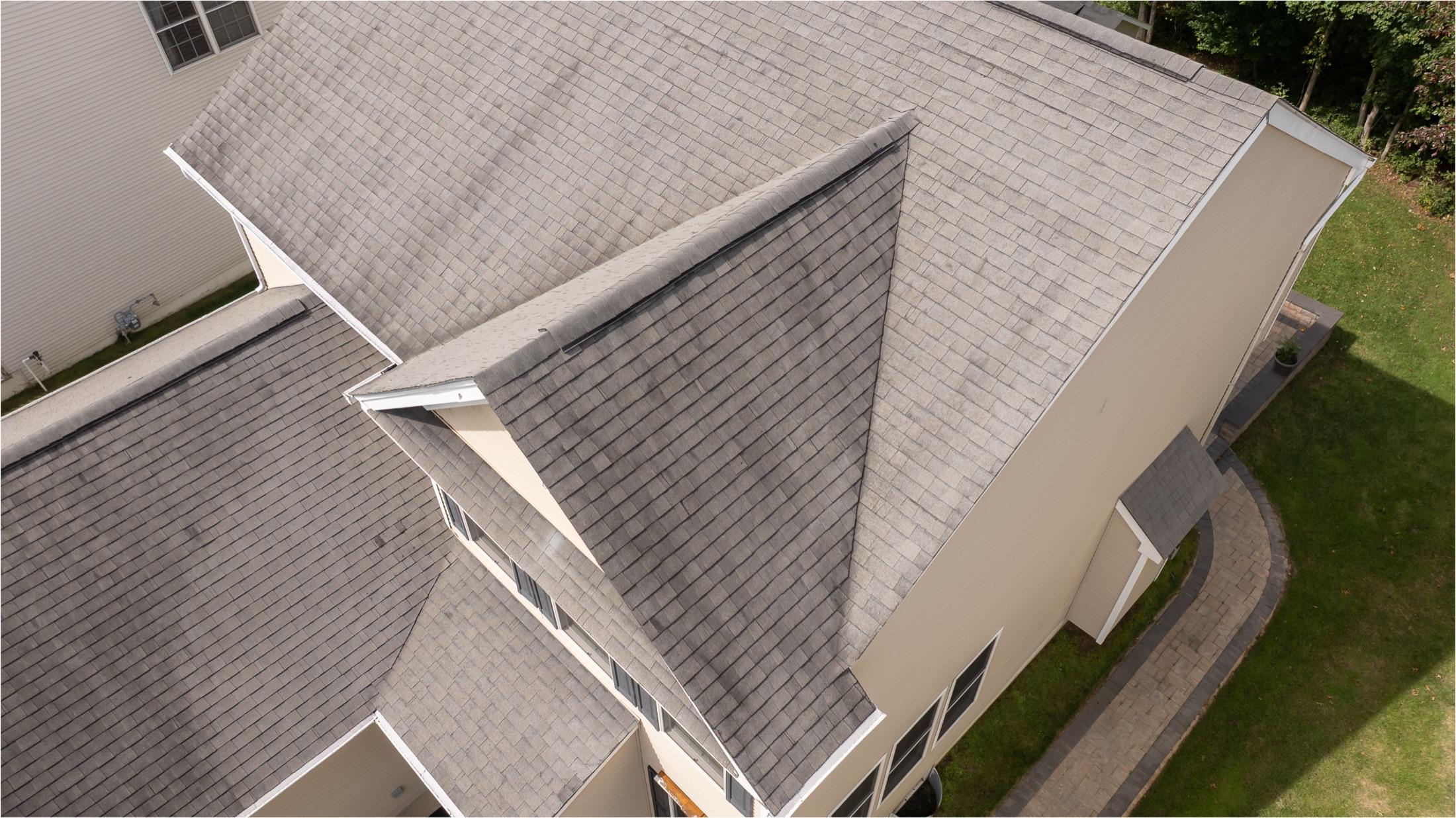 Angled aerial close view of intersecting roof planes and valleys