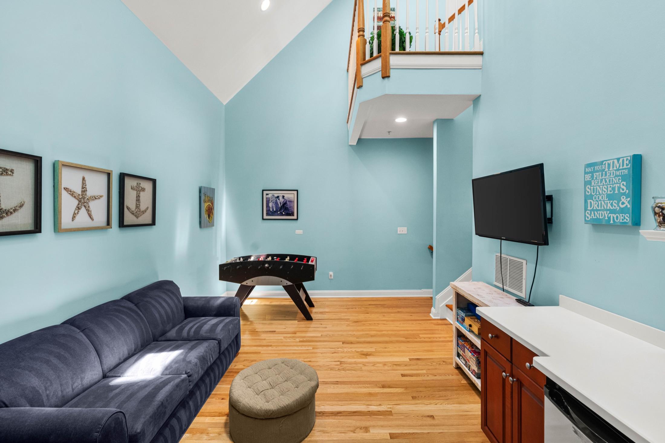 Loft den with foosball, sofa and TV under a vaulted ceiling, Seaside Heights rental