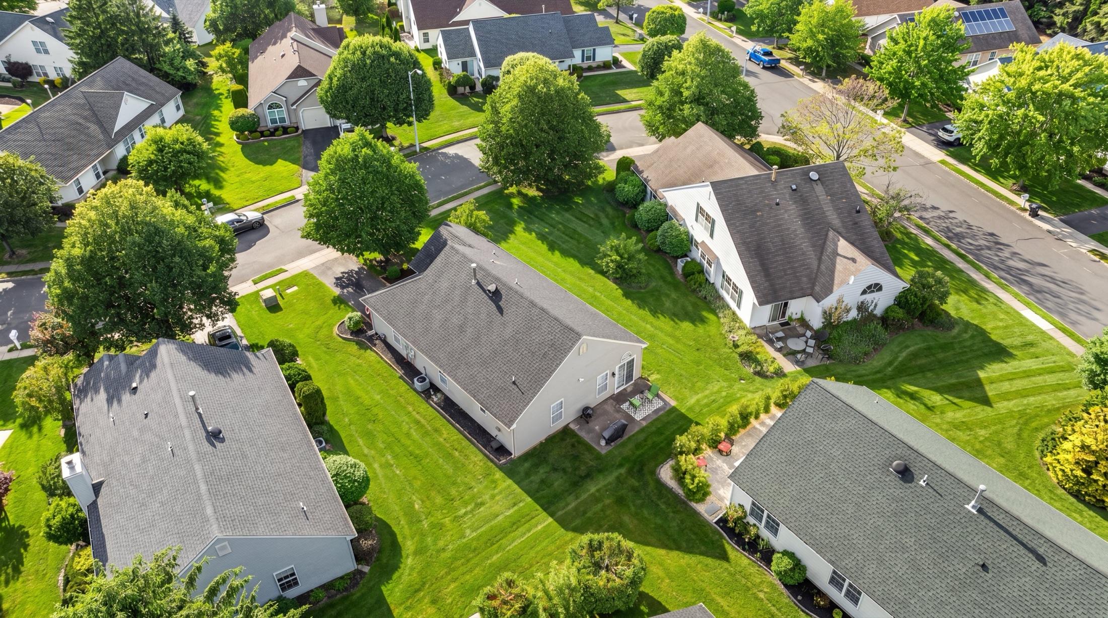 Same exterior with an enhanced green lawn
