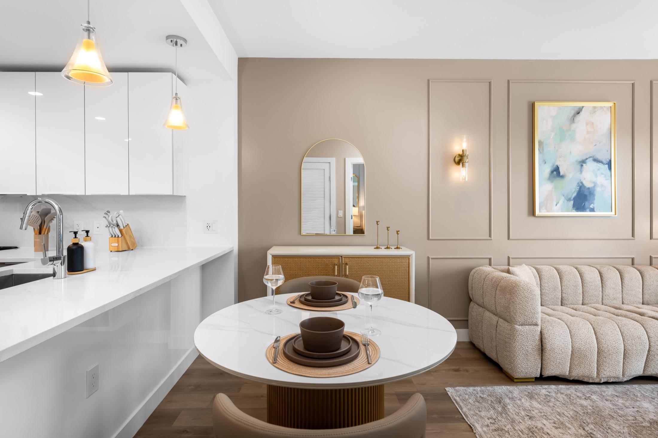 Styled dining nook and kitchen with a set table in a furnished condo, Hamilton Cove NJ