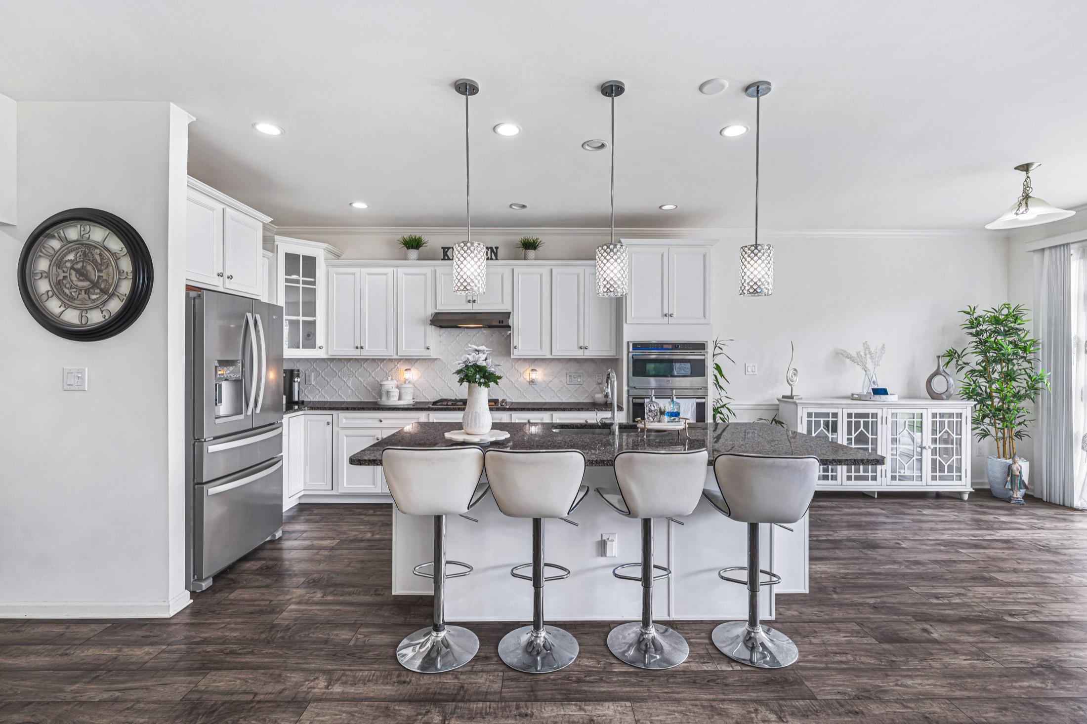 Bright white kitchen with a large island and bar seating