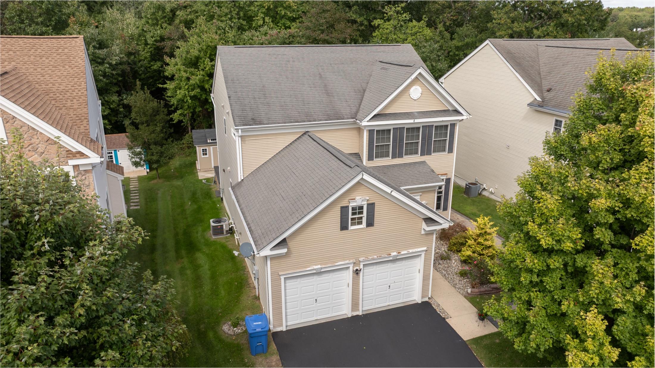 Aerial overview of a colonial home and its full roof, drone documentation