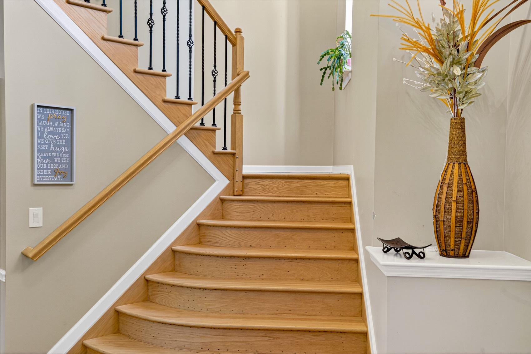 Curved hardwood staircase with a decorative entry detail