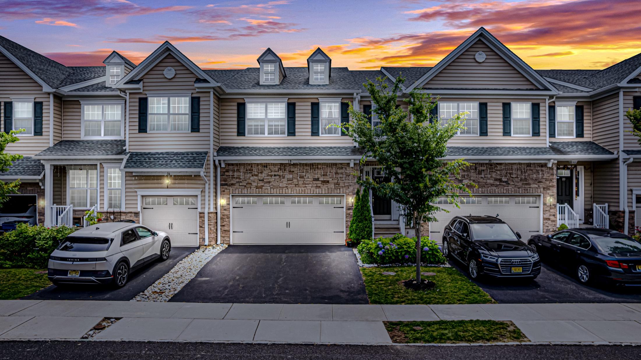 Townhouse exterior photographed at twilight with a glowing sunset sky